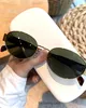 Oval sunglasses for women and men with a modern metal frame and classic shades Oval sunglasses for women and men with a modern metal frame and classic shades