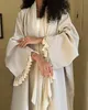 Traditional elegant women's abaya in the Middle East, long, loose robe, an open coat from the front without a scarf Traditional elegant women's abaya in the Middle East, long, loose robe, an open coat from the front without a scarf
