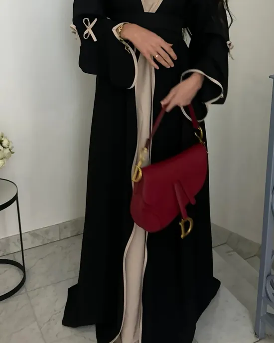 A new, elegant black black abaya for the year 2025 for Muslim women, with a belt design with a bow and a long, modest dress for the Middle East A new, elegant black black abaya for the year 2025 for Muslim women, with a belt design with a bow and a long, modest dress for the Middle East