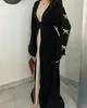 A new, elegant black black abaya for the year 2025 for Muslim women, with a belt design with a bow and a long, modest dress for the Middle East A new, elegant black black abaya for the year 2025 for Muslim women, with a belt design with a bow and a long, modest dress for the Middle East